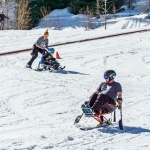 Skiers using sit-skis on the hill