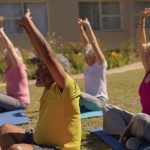 Elders in stretching while in a yoga class